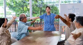 At home care service nurse caregiver take the lead to elderly person exercise in every morning
